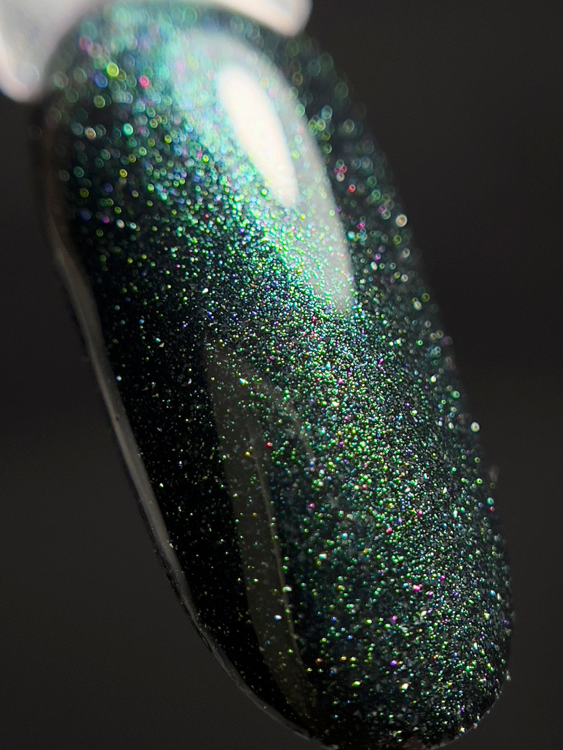     Cat eye gel polish by GLOSS with magnetic shimmer effect and reflective finish for professional nail designs