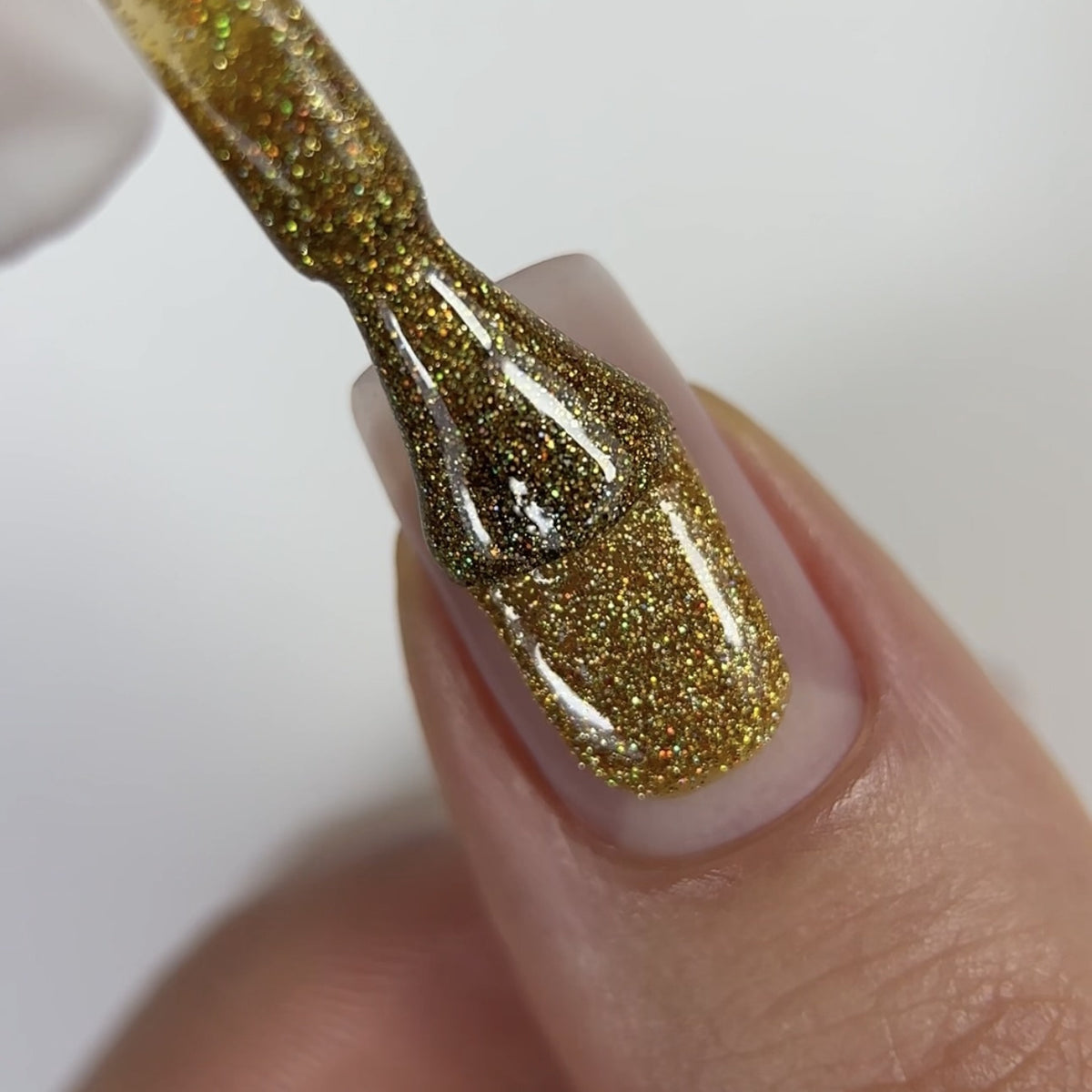 Yellow Gold gel manicure: GLOSS 400 gel polish on a nail, close-up photo
